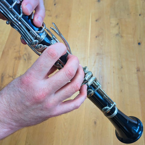 Photo of Guy Thackeray's hands playing the clarinet